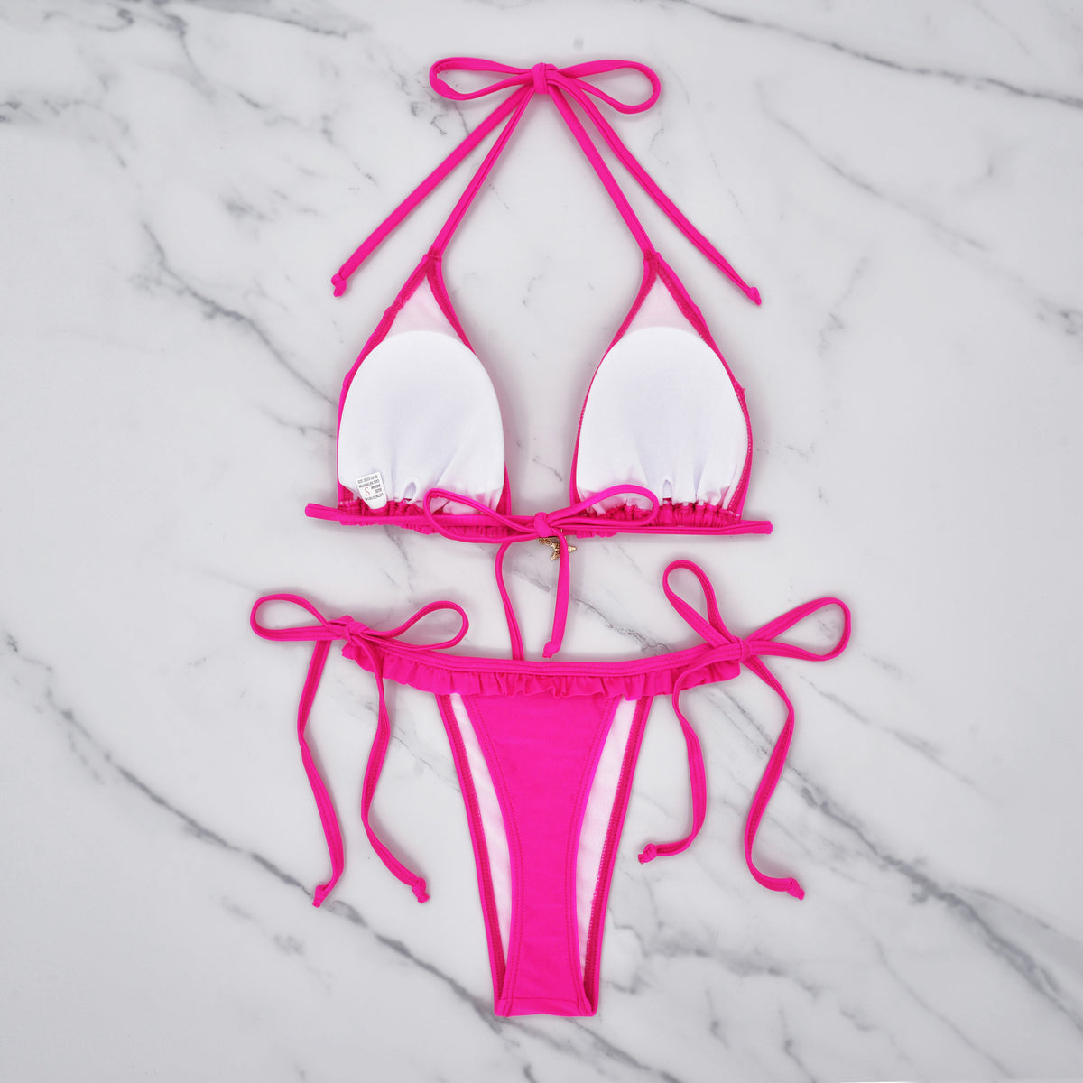 White triangle bikini set with pink ruffle trim, halter top, and tie-side bottoms