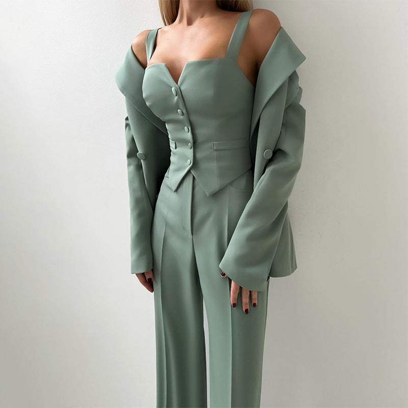 Three-piece suit set in muted green with button-front vest, long blazer, wide-leg pants