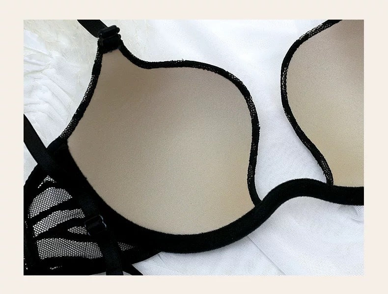 Black mesh plunge bra close-up with scalloped edge and adjustable straps