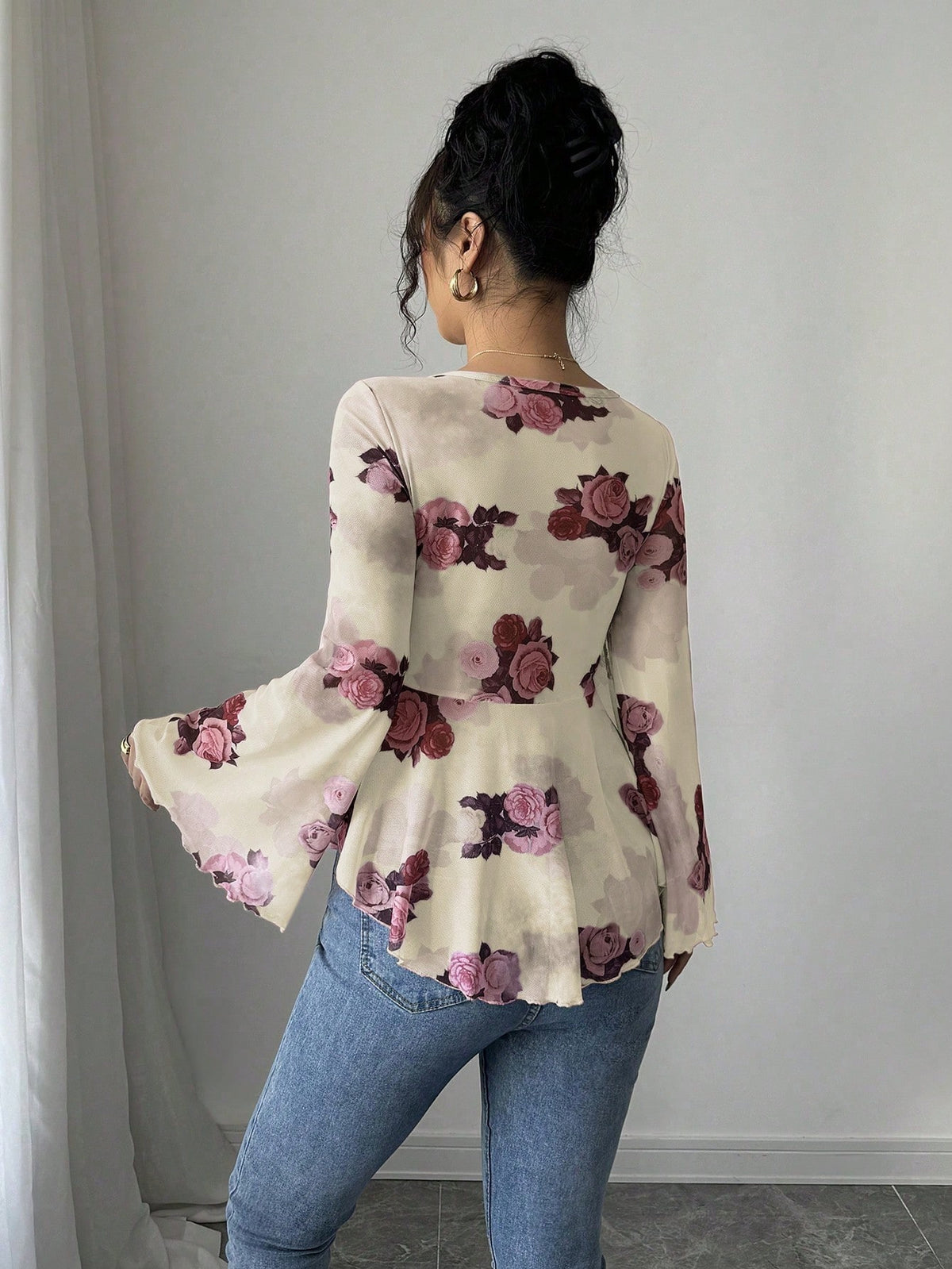 Light purple floral blouse with bow front, bell sleeves, flared hem; back view