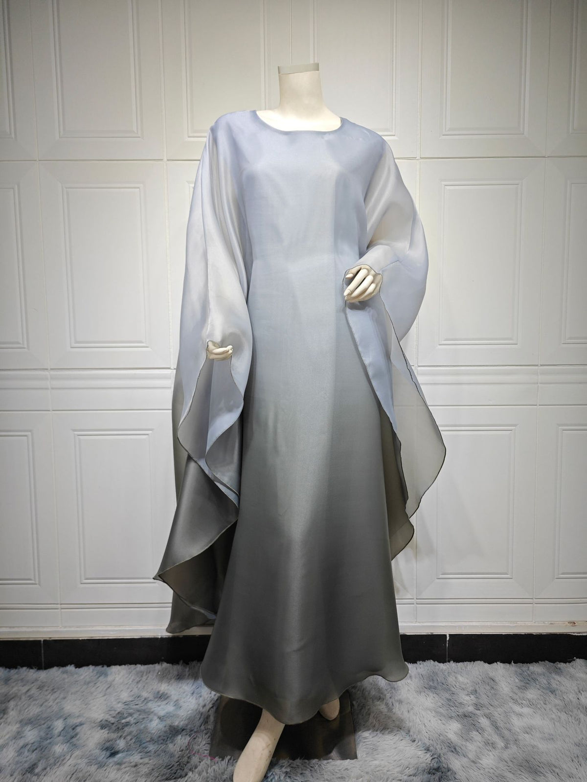 Ombre satin maxi dress with sheer draped batwing sleeves in gray-to-silver.