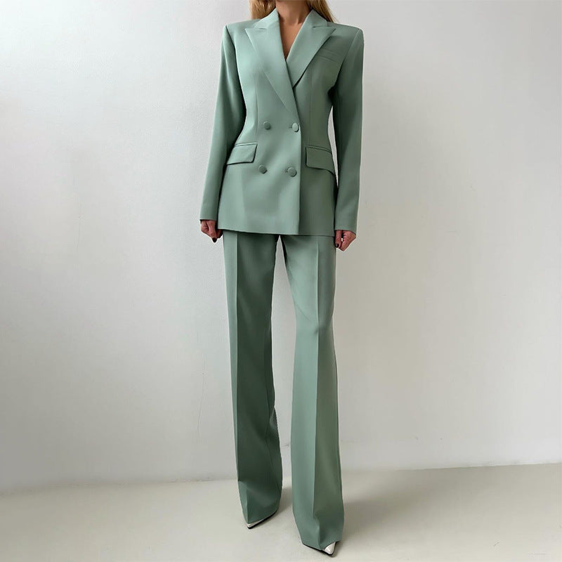 Three-piece suit set in muted green: tailored blazer over button-front vest with wide-leg pants