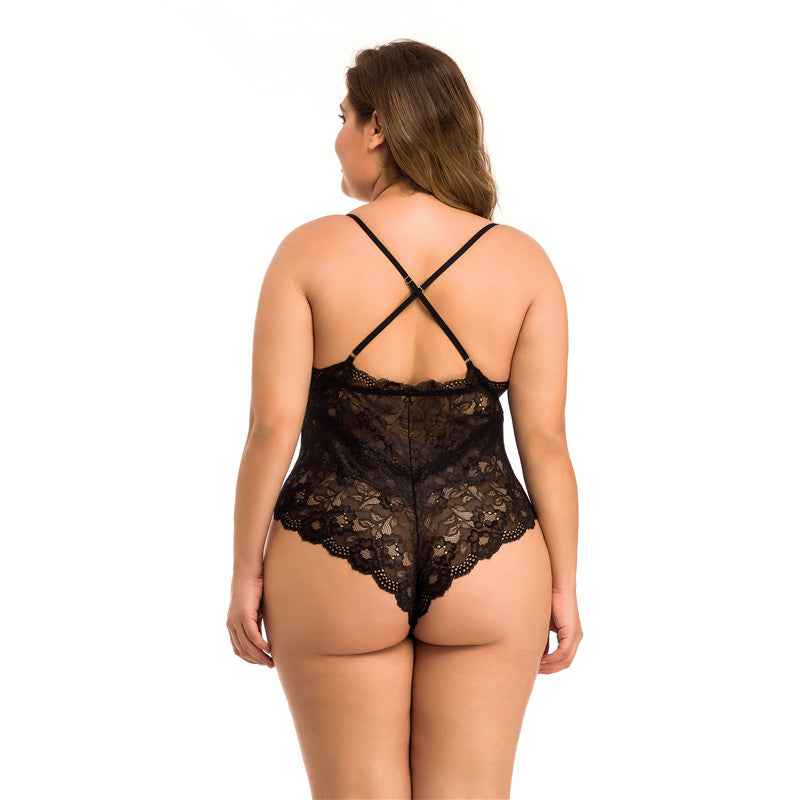 A woman viewed from the back wearing a black lace bodysuit with thin crisscross shoulder straps and a scalloped lace waistband, against a plain white studio background.