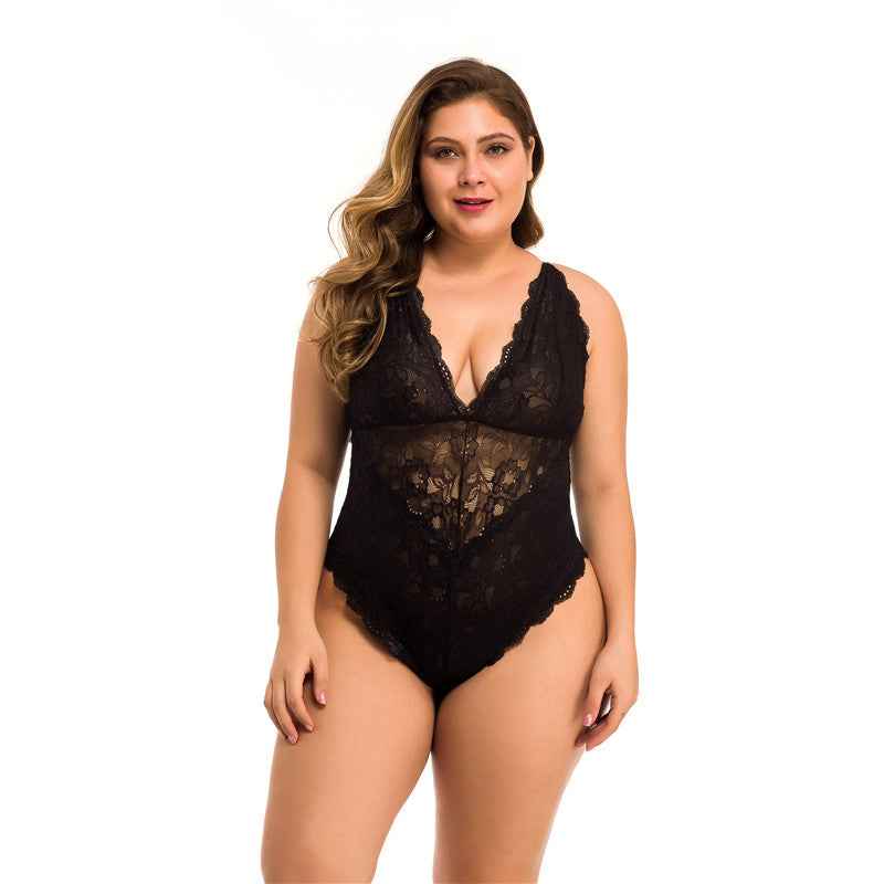 A woman modeling a black lace bodysuit with a deep V-neckline and sheer floral lace panels on a solid white background.