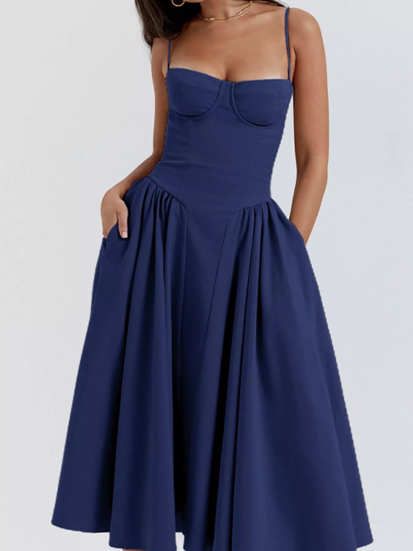 Navy blue dress with thin straps on a white background