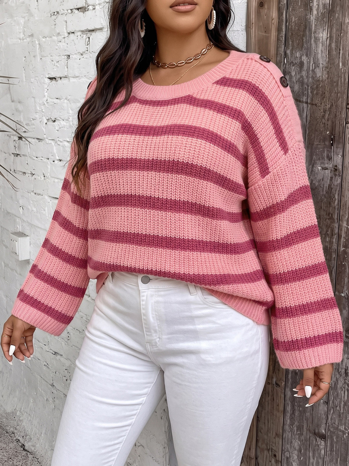 Pink striped knit pullover sweater with wide bell sleeves and ribbed crew neckline