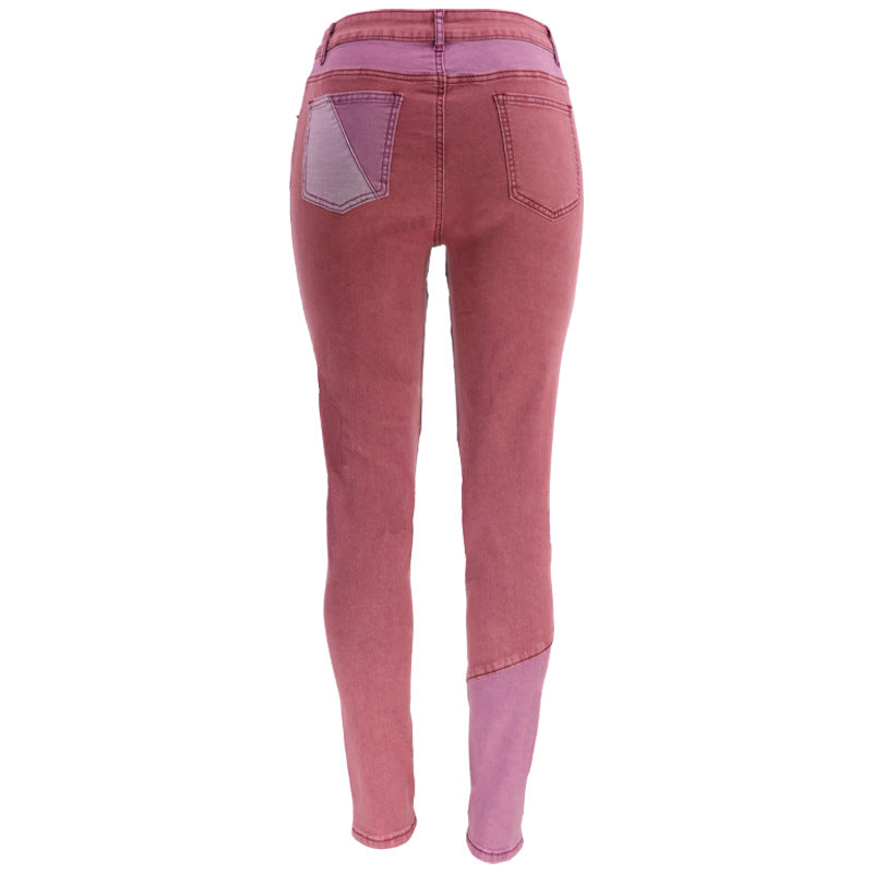 High-waist patchwork slim jeans in mauve pink with light pink angled panels at the thighs.
