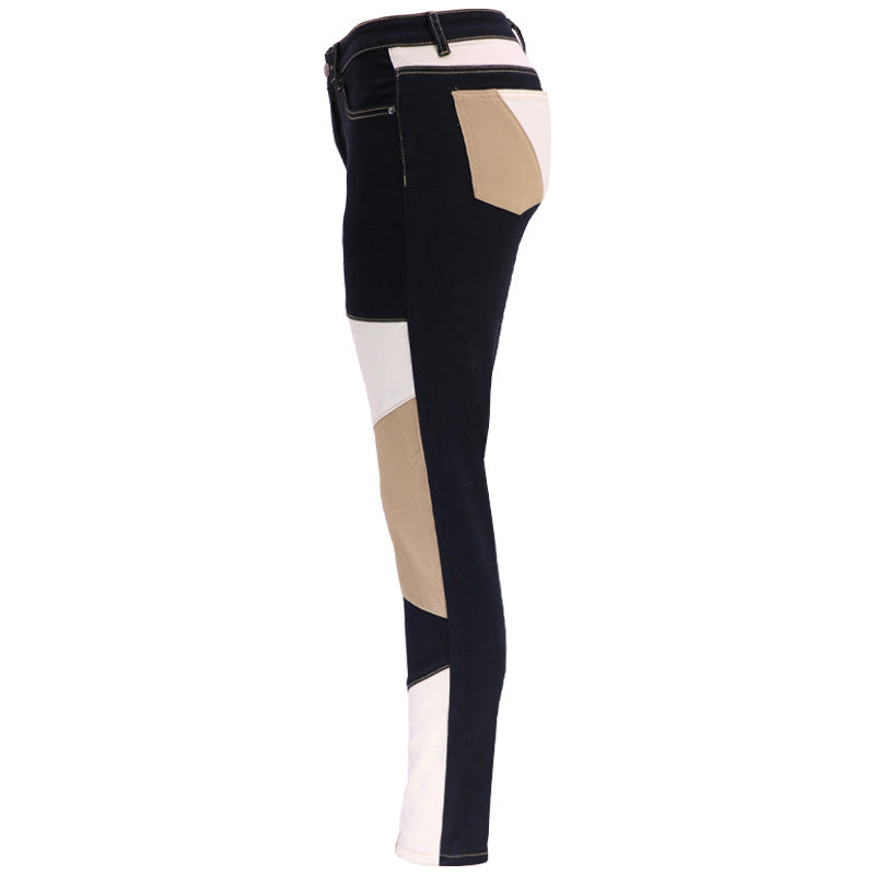 High-waist patchwork slim jeans, dark blue-black with beige and white block panels on the legs.
