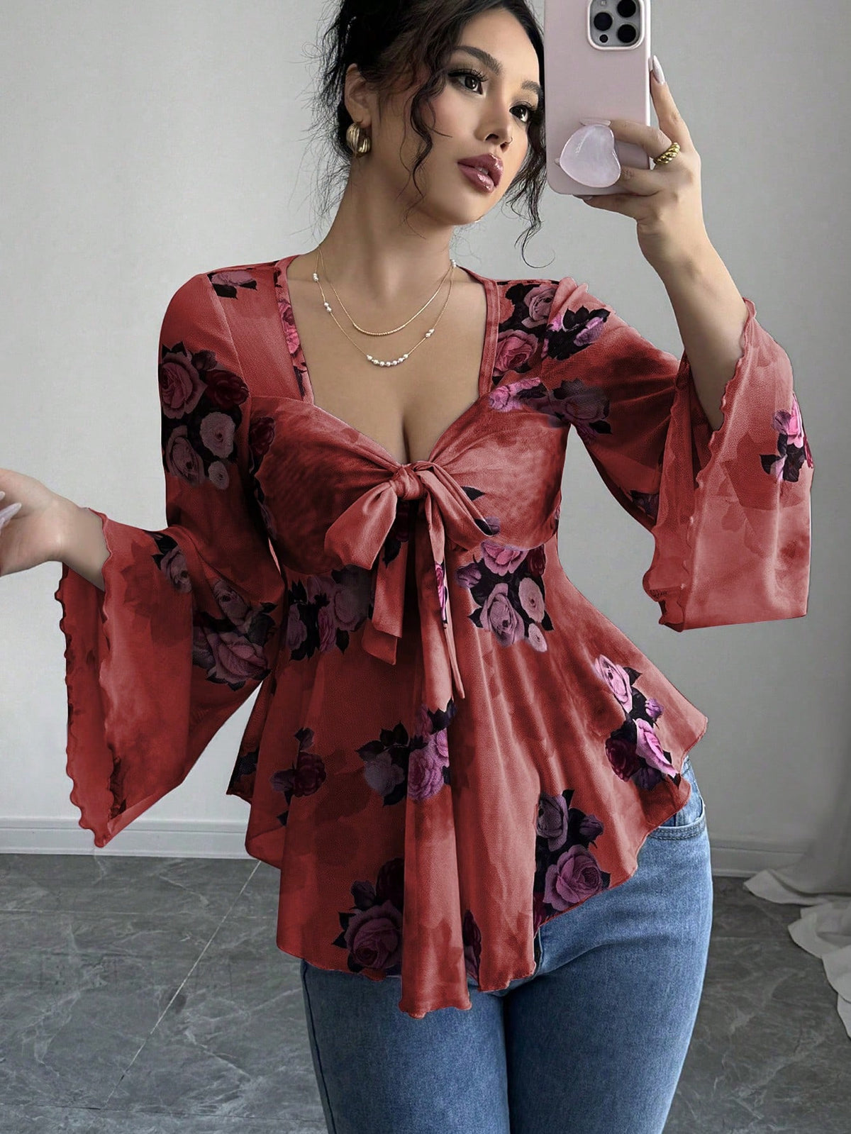 Floral bow-front blouse in red with long bell sleeves and flared hem