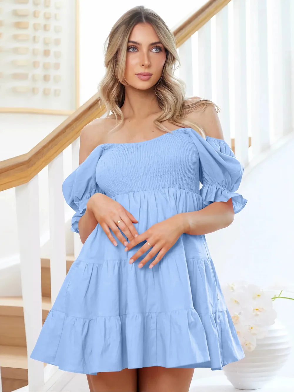 Light blue off-shoulder smocked mini dress with puff sleeves and tiered skirt