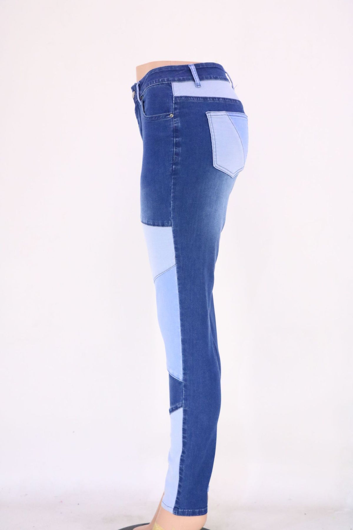 High-waist patchwork slim jeans in medium blue with light blue paneling on the legs.
