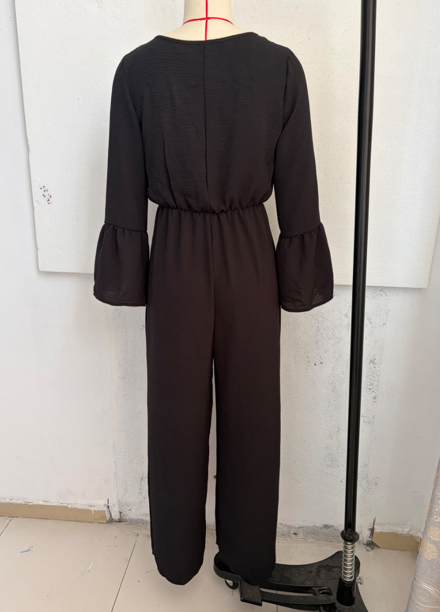 Black wide-leg jumpsuit with gathered waist and flared sleeves, back view