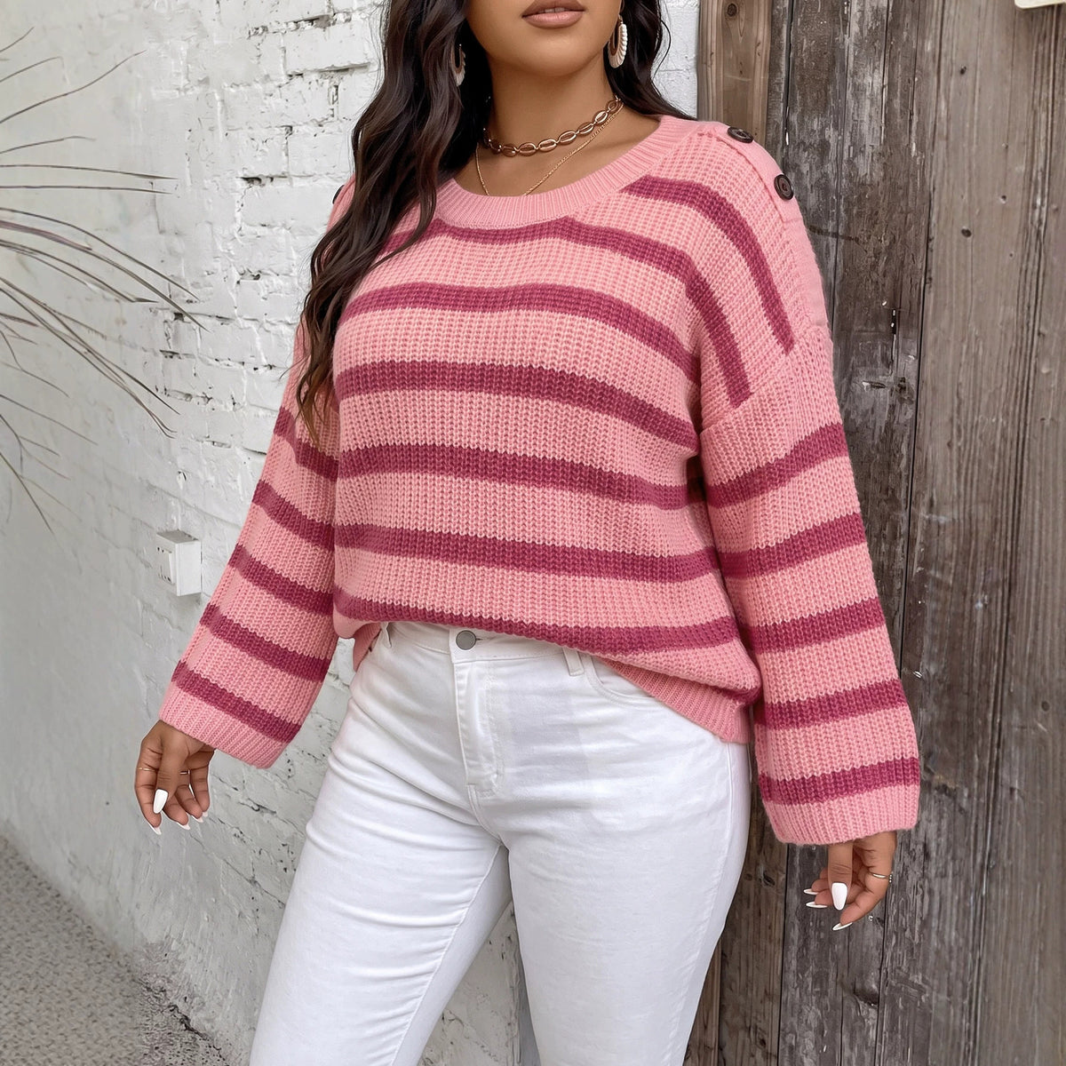 Pink and magenta striped knit pullover sweater with wide bell sleeves and crew neck