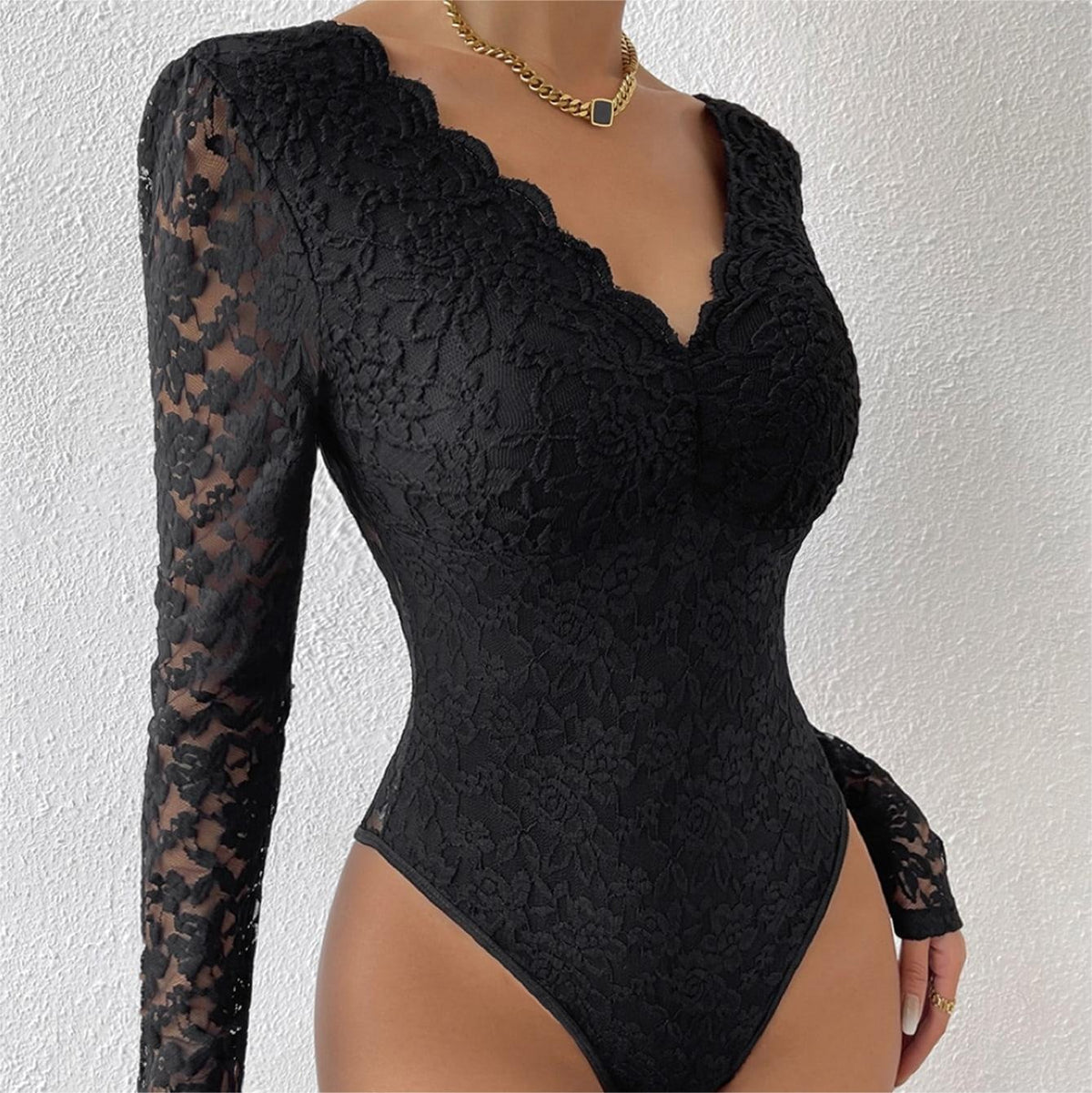 Black lace bodysuit with scalloped V-neck and sheer long sleeves