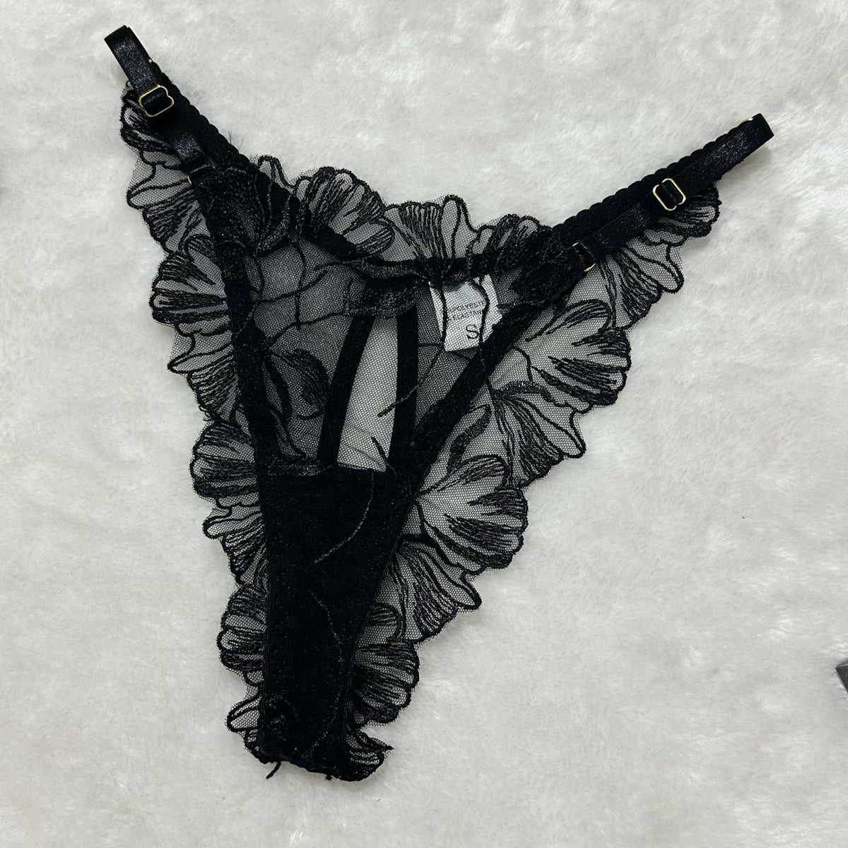 Black sheer floral lace thong with bow detail and adjustable garter straps