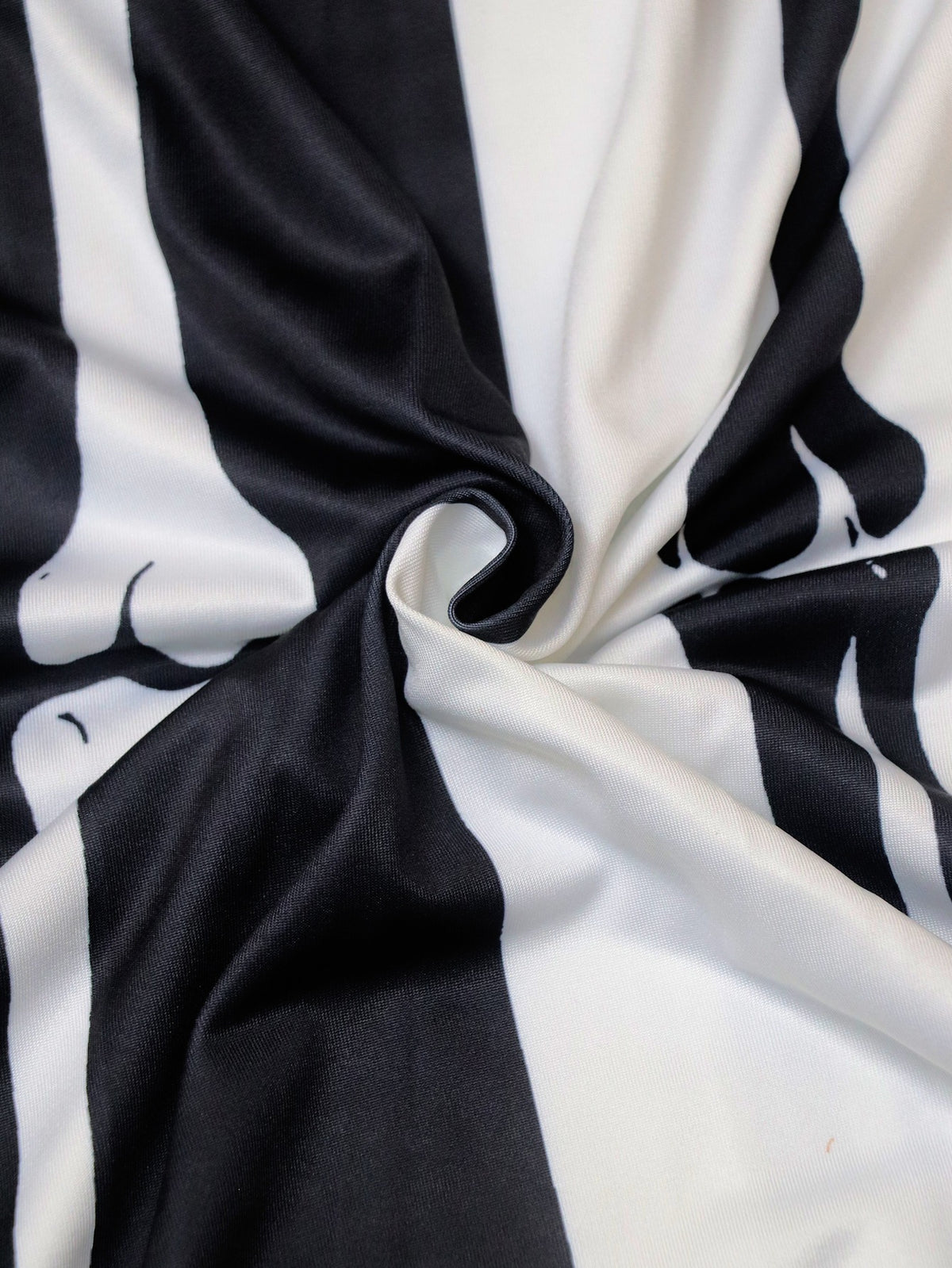 Black and white printed fabric with twisted skeleton-themed design