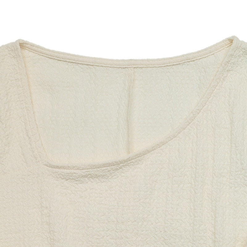 Cream knit dress neckline with soft scoop back and textured fabric
