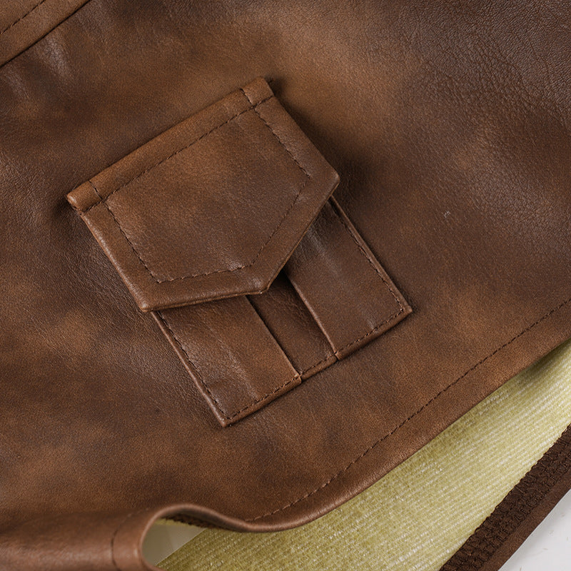 Back patch pocket detail with stitching on brown leather-look shorts.