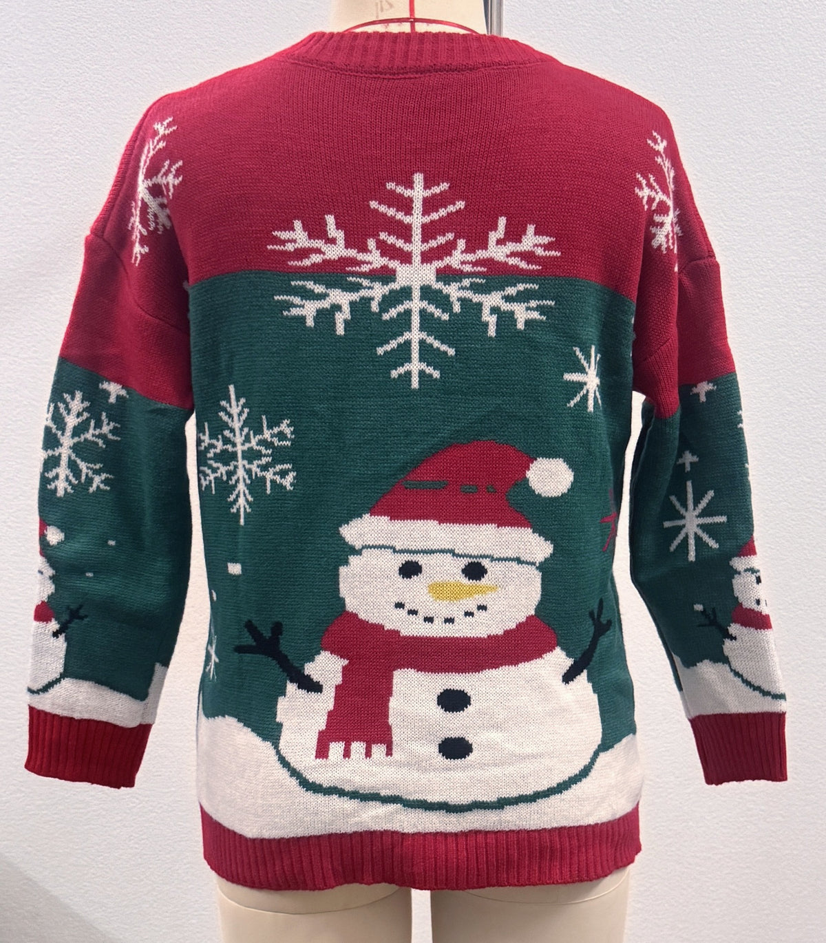 Back view red crewneck Christmas sweater with snowman and snowflakes, ribbed hem