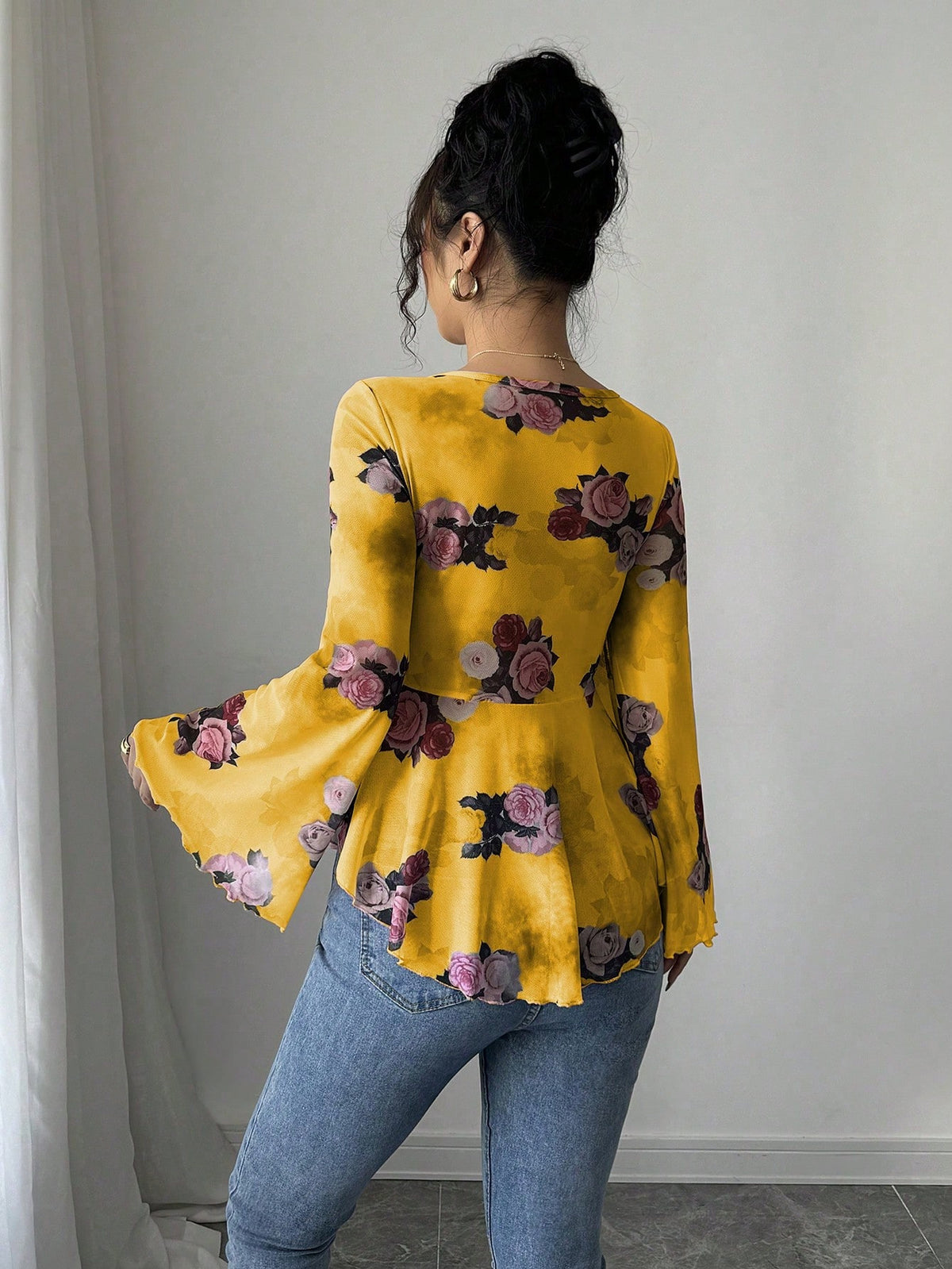 Yellow floral blouse with bow front, bell sleeves, flared hem; back view