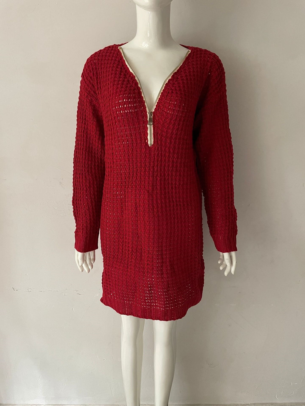 Red V-neck knit sweater dress with zip neckline and ribbed cuffs on mannequin