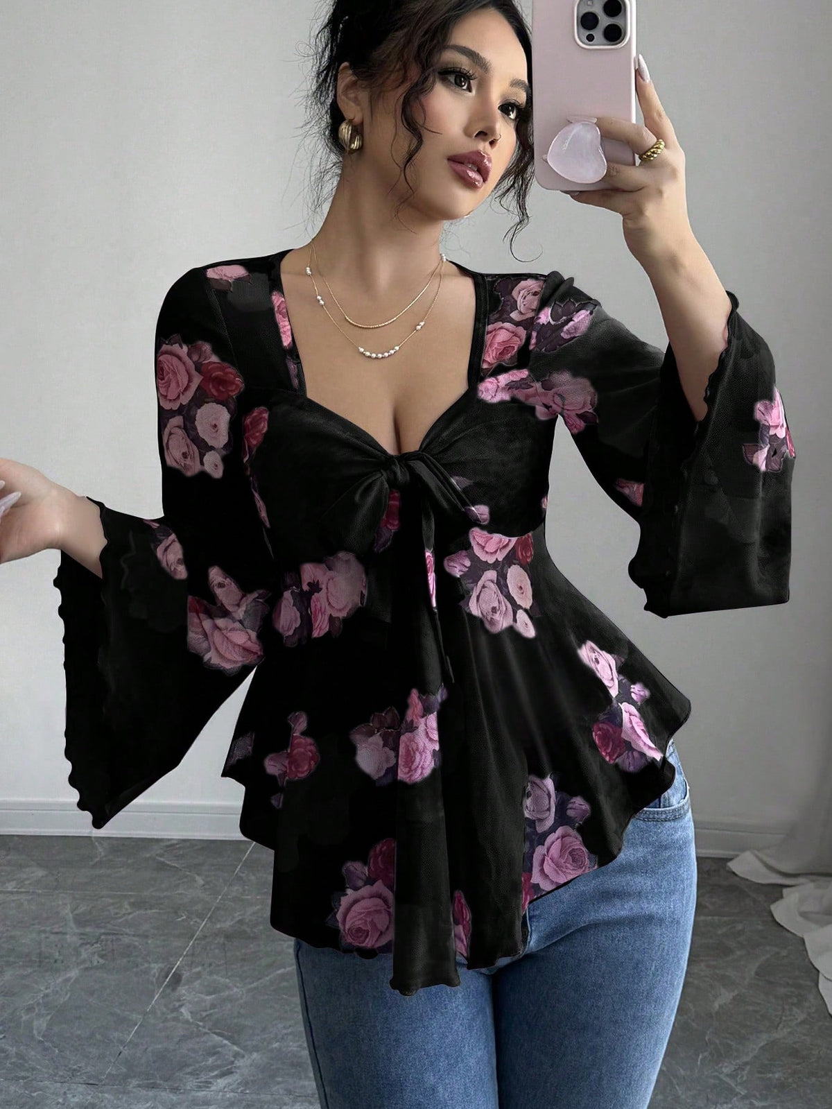 Floral bow-front blouse in black with long bell sleeves and flared hem