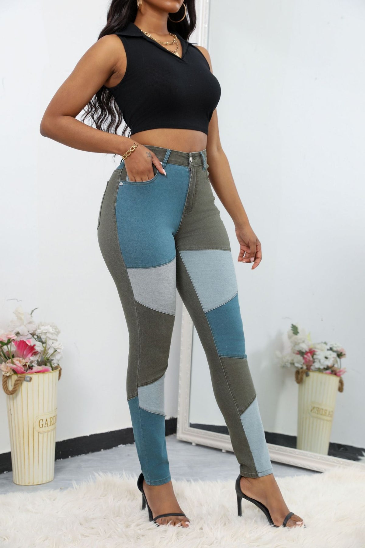 High-waist patchwork jeans with angled panel seams and slim leg, teal, gray, and light blue paneling.
