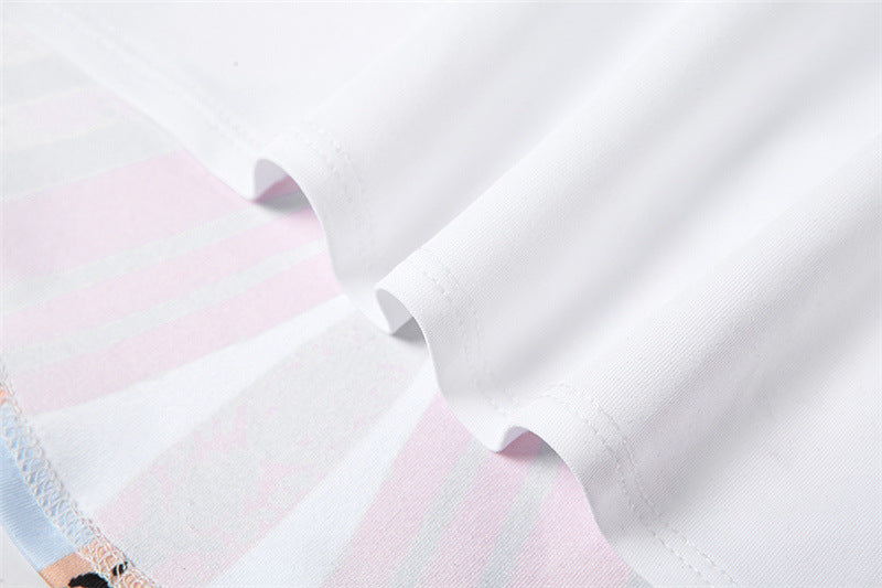 Close-up of white fabric with multicolor butterfly print trim on crop top