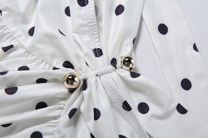 White polka-dot top with ruched front, drawstring, and gold button hardware