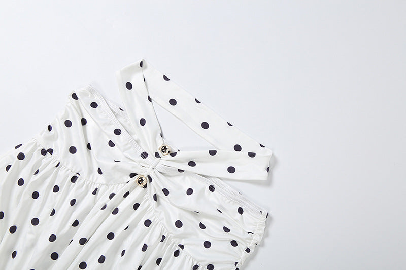 White polka-dot off-shoulder top with gathered neckline and gold button accents
