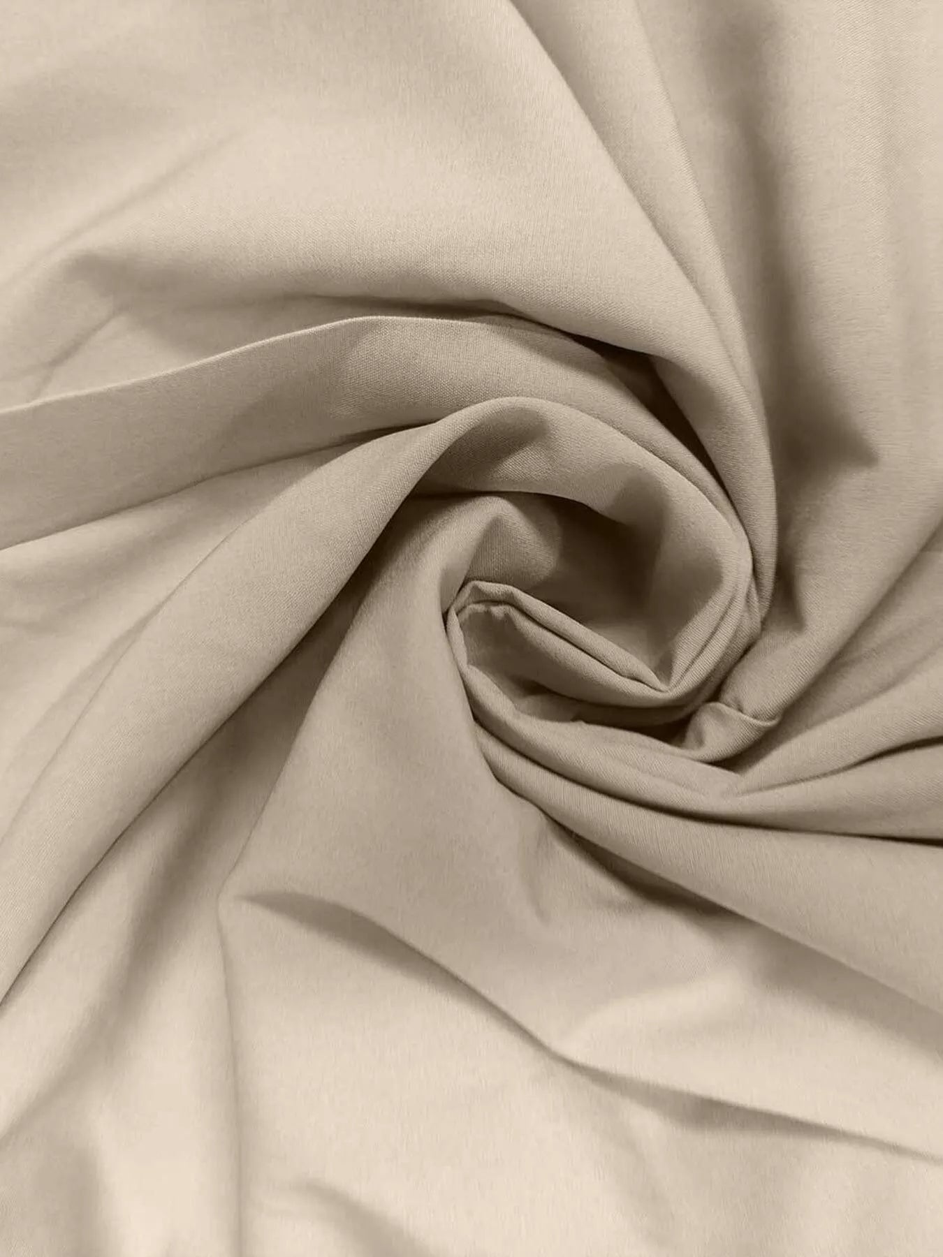 Close-up of beige fabric with folds