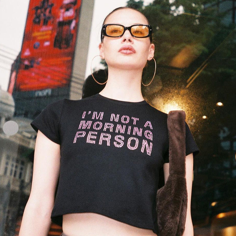 Trendsi black Crop T-Shirt with IM NOT A MORNING PERSON slogan on model wearing sunglasses and hoop earrings