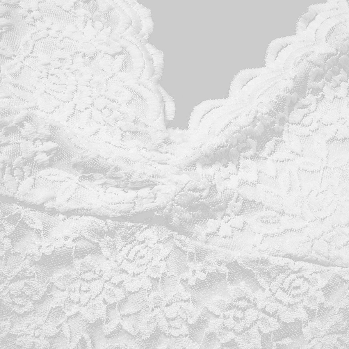 White lace bodysuit detail close-up of floral textured fabric
