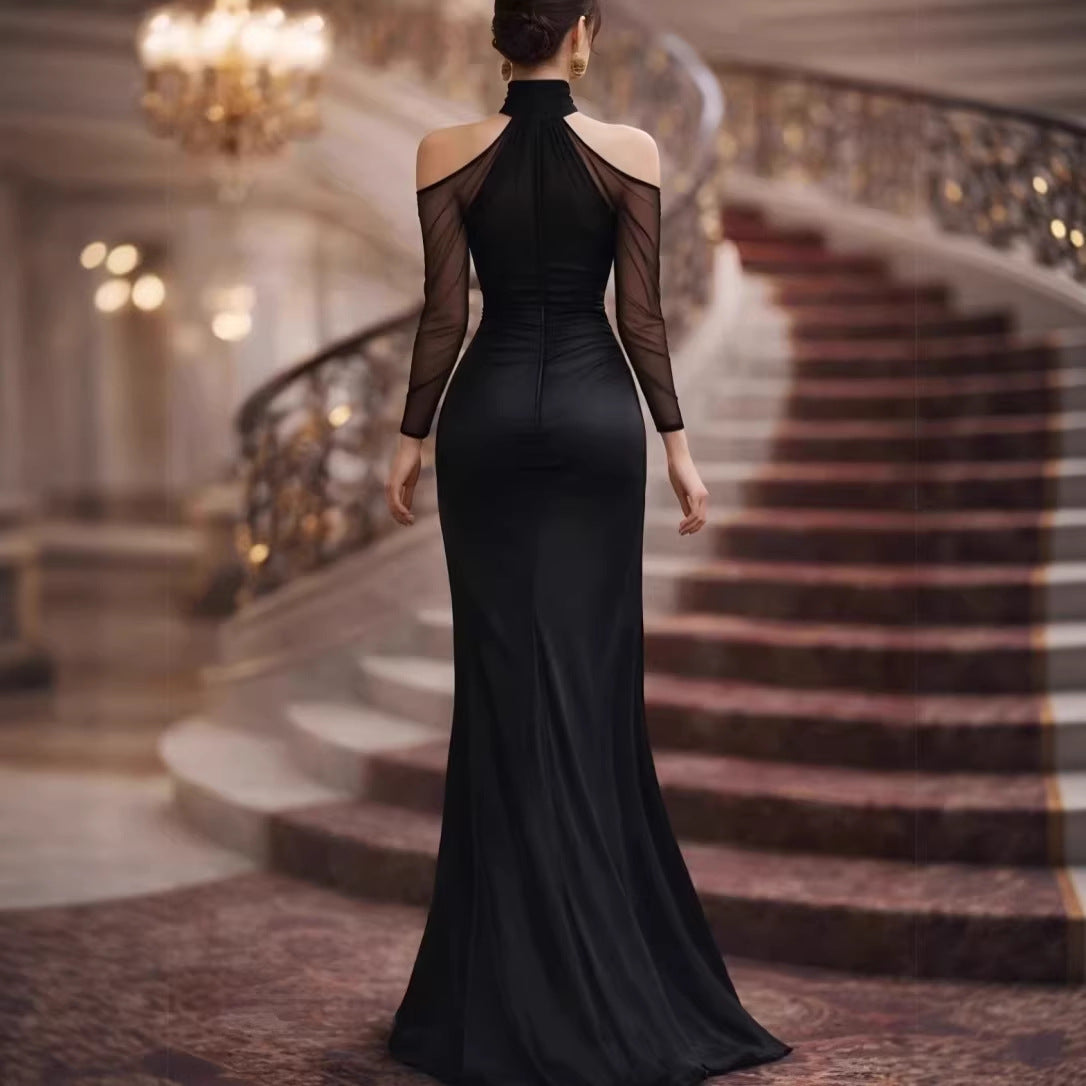 Black evening gown, back view, sheer long sleeves and high neck with ruched waist