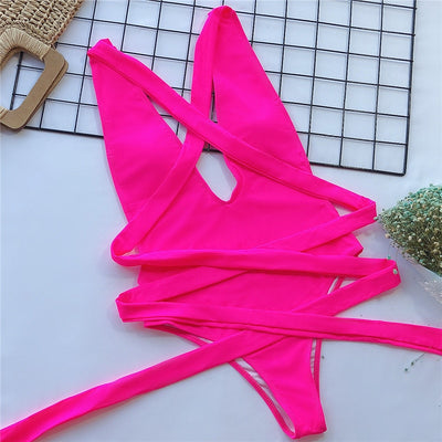 Rose-red one-piece swimsuit with crossed straps and wrap-tie waist, bright pink