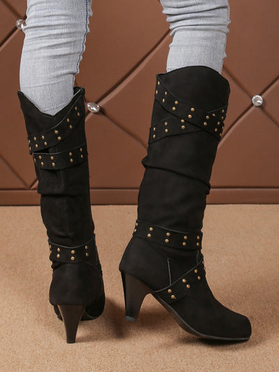 Black tall western boots with studded strap accents and side zipper, heeled