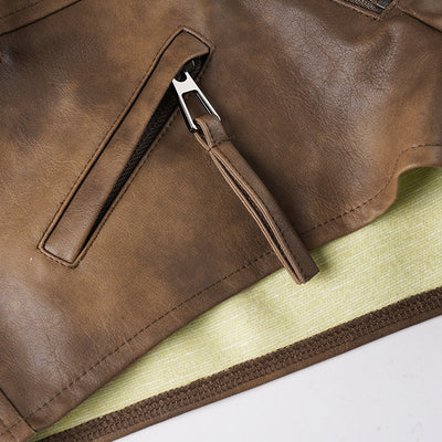 Close-up of front zip fly and bartack stitching on brown leather-look shorts.