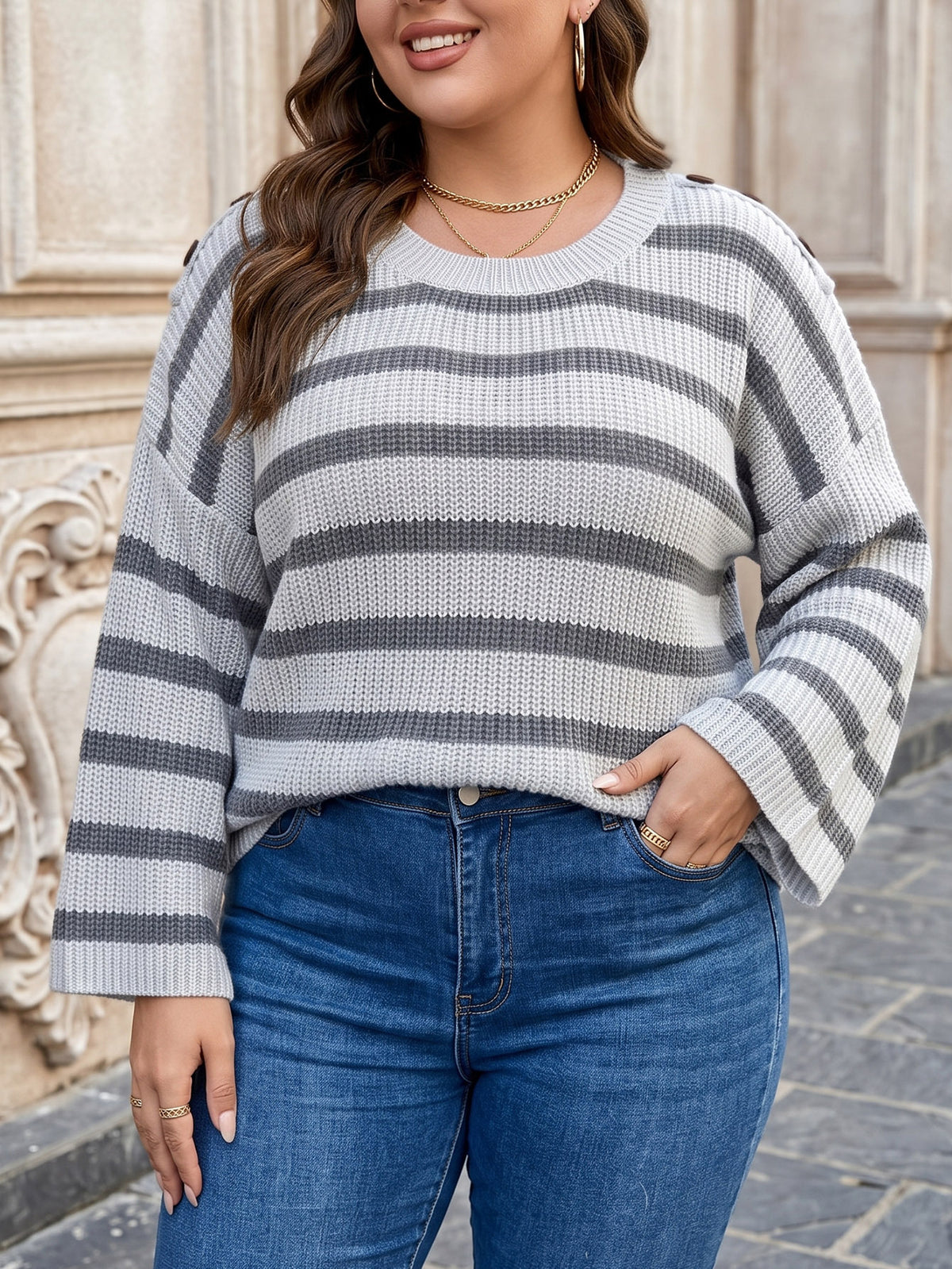Gray striped knit pullover sweater with wide bell sleeves and ribbed crew neckline