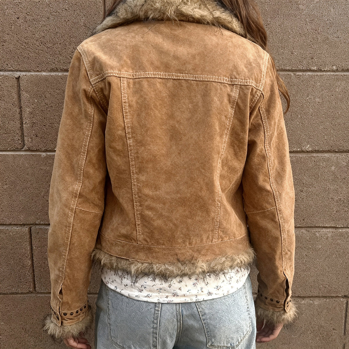 Khaki jacket back with panel seams and faux-fur trim around the hem