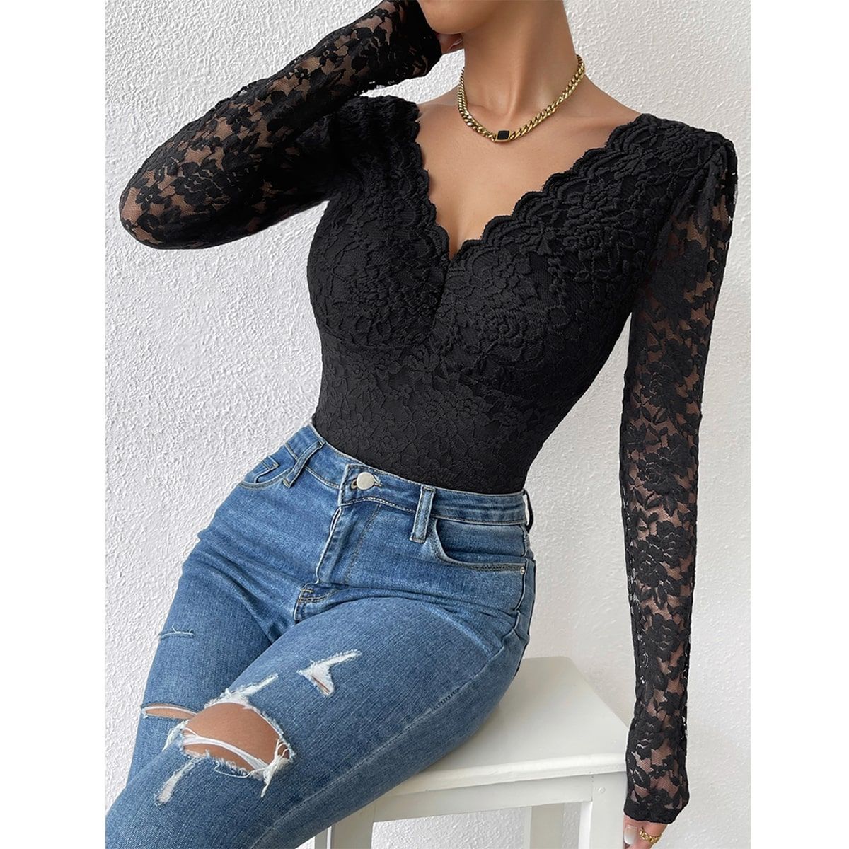 Black lace bodysuit with scalloped V-neck and sheer long sleeves