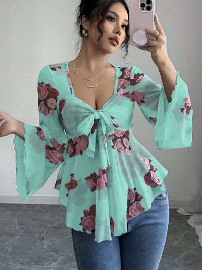 Floral bow-front blouse in turquoise with long bell sleeves and flared hem