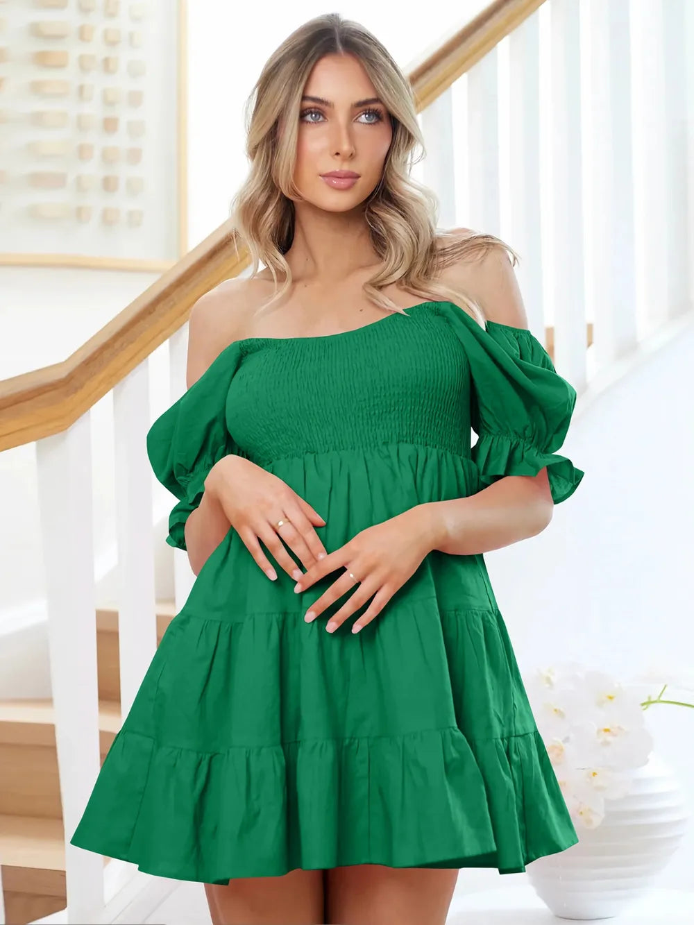 Dark green smocked mini dress with off-shoulder neckline and puff sleeve cuffs