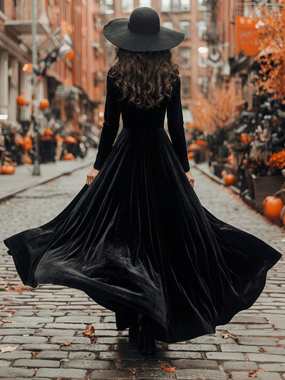 Black velvet maxi dress with long sleeves and wide flared skirt