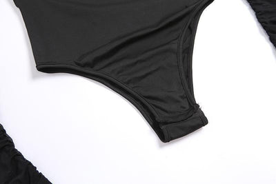 Close-up of a black one-piece swimsuit bottom or bikini bottom laid flat on a white background.
