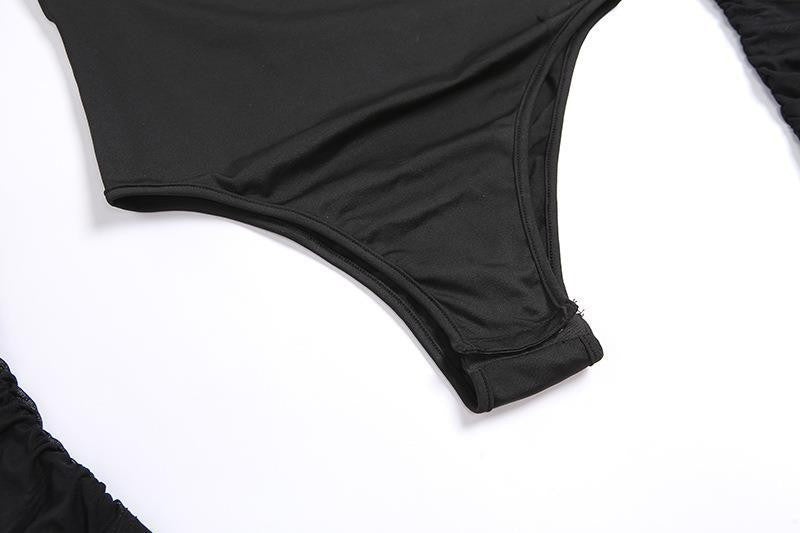 Close-up of a black one-piece swimsuit bottom or bikini bottom laid flat on a white background.