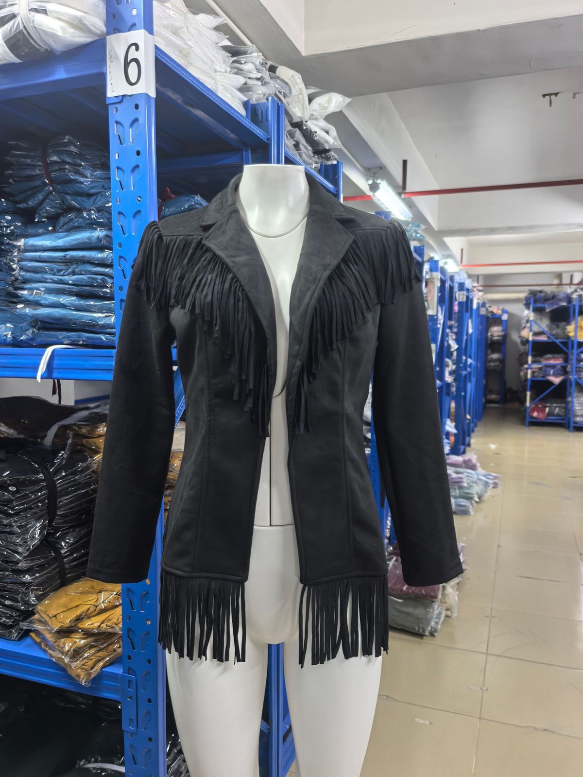 Black fringe jacket with notched lapels and shaped seams, fringe cuffs and hem