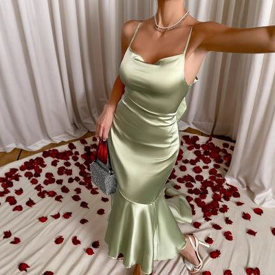Light green satin mermaid dress with thin straps and flounced hem, side view
