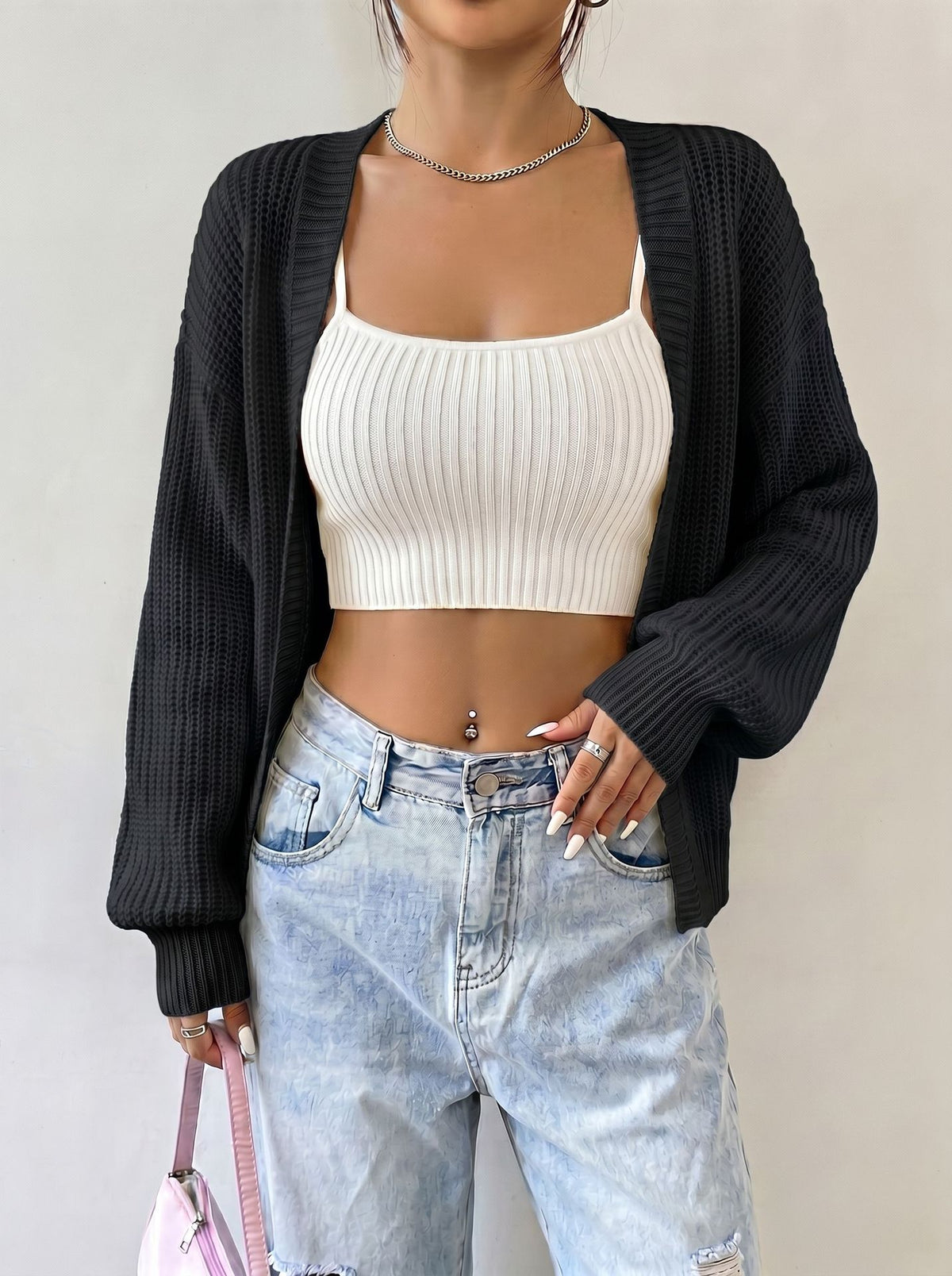 Black open-front knit cardigan with balloon sleeves and ribbed texture