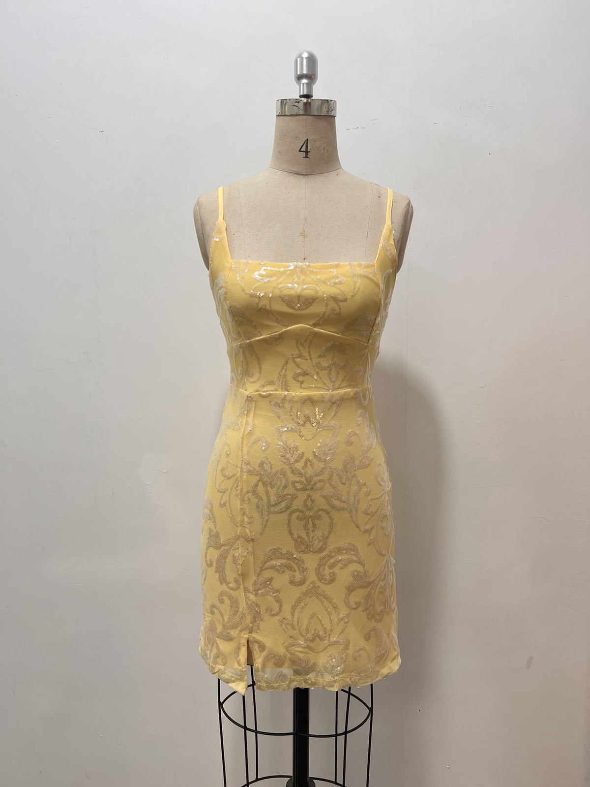 Yellow sequin mini dress with thin straps and ornate lace pattern