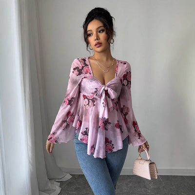 Floral bow-front blouse in light purple with long bell sleeves and flared hem